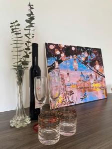 a table with two glasses and a bottle of wine at Cibi's Homestay - Tra Khuc riverside in An Bình (1) +49 photos