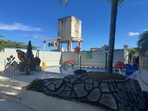 a pool with a palm tree and a water park at Serra Park in Rio Quente +2 photos