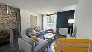 a living room with a couch and a table at Le vieux tilleul in Bessines-sur-Gartempe
