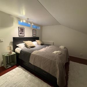 a bedroom with a large bed and a blue window at Seaview apartment in Mariehamn