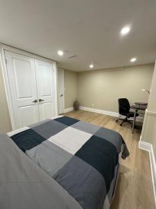 a bedroom with a bed and a desk in it at The Perfect Getaway in Orangeville