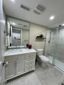 a bathroom with a sink and a toilet and a shower at The Perfect Getaway in Orangeville +13 photos