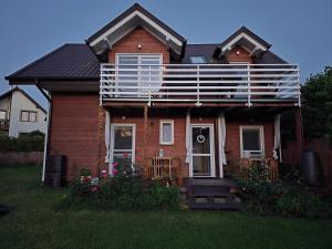 a house with a balcony on the front of it at Morski 1 in Stegna