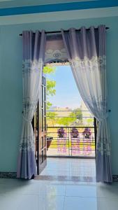 an open door with a view of a balcony at Beachside Home, Ngũ Hành Sơn, Đà Nẵng in Da Nang