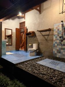 a bathroom with a toilet in a room at Lihat Sawah Cottage in Sidemen