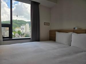 Krevet ili kreveti u jedinici u okviru objekta Henn na Hotel Seoul Myeongdong
