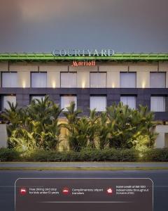 a rendering of a hotel with palm trees in front of it at Courtyard by Marriott Kochi Airport in Nedumbassery