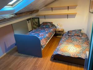 two beds in a small room with a attic at Les terrasses des pourquiers in Gordes +9 photos