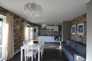 a living room with a couch and a table at Apartament Nad Morzem in Rowy