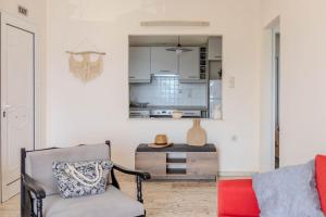 a living room with a chair and a table at Helen's Seaview in Aliveri