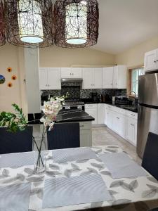 a kitchen with white cabinets and a black counter top at Casa en La Trinidad in La Unión