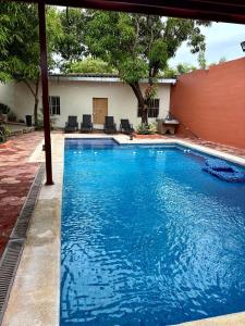 a large pool with blue water in a yard at Casa en La Trinidad in La Unión