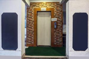 a door in a brick building with a sign on it at Hotel O Grandeur in Méribel Village