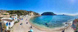 a group of people on a beach with the ocean at Casa Halcón in Jávea