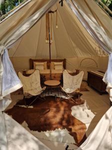 a tent with a table and chairs in it at Glamping Štôla Brezovy vanok in Vyšné Hágy