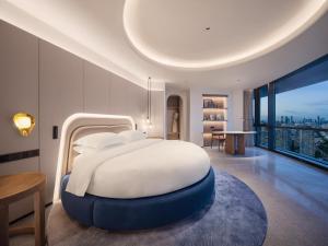 Postel nebo postele na pokoji v ubytování Aden Hotel Shenzhen Nanshan