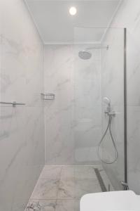 a bathroom with a shower with a glass door at Evdokia Artheon in Rhodes Town