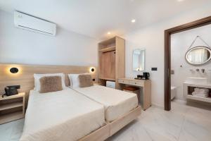 a bedroom with a large bed and a sink at Evdokia Artheon in Rhodes Town