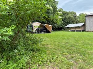 a group of tents in a grass field at Tente safari in Sainte-Soulle