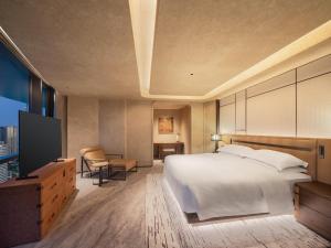 Postel nebo postele na pokoji v ubytování Aden Hotel Shenzhen Nanshan
