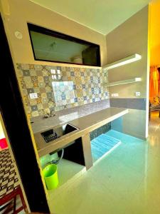 a kitchen with a sink and a counter top at The Hp 39 House in Dharmsala