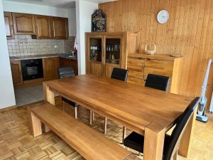 a kitchen with a large wooden table and chairs at Spacieux appartment 4 Vallées La Tzoumaz Verbier in Riddes +9 photos