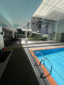 a large swimming pool in a building with a building at Antel Spa Residences 7OB in Manila
