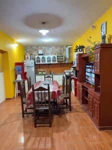 a kitchen with a table and a kitchen with yellow walls at Casa Tomas 2 in Villa Unión