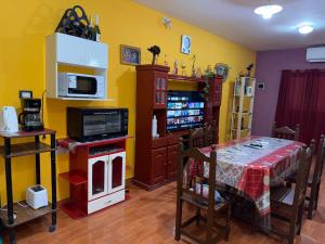 a dining room with a table and a microwave at Casa Tomas 2 in Villa Unión +12 photos