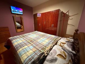 a bedroom with a bed and a dresser and a tv at Casa Tomas 2 in Villa Unión