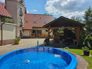 a swimming pool in the yard of a house at Dom Wypoczynkowy Leśniczówka 18 Węgierska Górka in Węgierska Górka