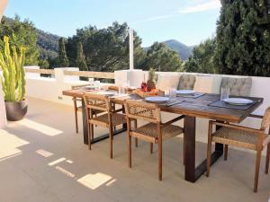 a wooden table and chairs on a patio at Casa Zita Mar 6p beach villa 5min walk in Cala Llonga +60 photos