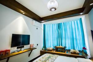 โทรทัศน์และ/หรือระบบความบันเทิงของ Qinghe Art Hotel