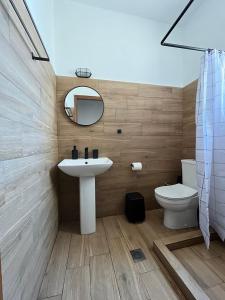 a bathroom with a sink and a toilet and a mirror at LaMar in Skala Prinou +25 photos