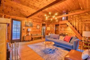 a living room with a blue couch in a cabin at Ray's Dear Cottage- A relaxing place in the woods in Wrightwood
