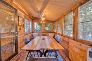 a dining room with a wooden table and chairs at Ray's Dear Cottage- A relaxing place in the woods in Wrightwood