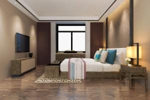 Rúm í herbergi á Hotel Vila Grand Near IGI Airport