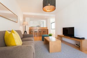 a living room with a couch and a tv at FLH Martim Moniz Modern Flat in Lisbon