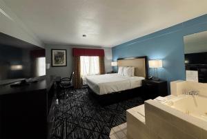 a hotel room with a bed and a bathroom at Baymont by Wyndham Litchfield in Litchfield +28 photos