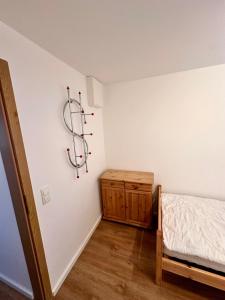 a bedroom with a bed and a wooden dresser at Ost See Blick Ferienwohnung Nr1 Baabe in Baabe +8 photos