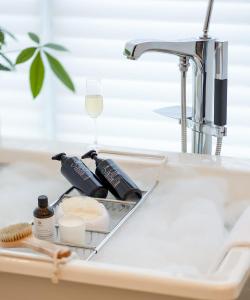 a sink with wine bottles and a glass at The St. Regis Chengdu in Chengdu