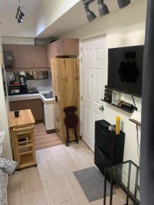 a small kitchen with a door and a table at EK's Place in Manila