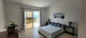 a bedroom with a bed and a large window at Seaview Villa,Black River Private Pool and Sunset in Tamarin +32 photos