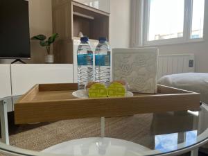 a coffee table with two bottles of water on it at Apartamento Son do Mar in Porto do Son +23 photos