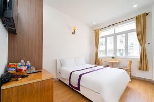 Postel nebo postele na pokoji v ubytování The Sim Hotel Vung Tau