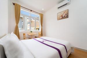 Postel nebo postele na pokoji v ubytování The Sim Hotel Vung Tau