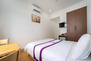 Postel nebo postele na pokoji v ubytování The Sim Hotel Vung Tau