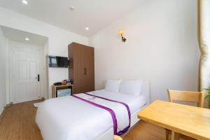 Postel nebo postele na pokoji v ubytování The Sim Hotel Vung Tau