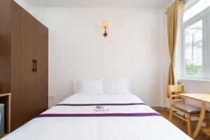 Postel nebo postele na pokoji v ubytování The Sim Hotel Vung Tau