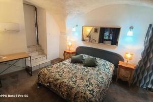 a bedroom with a bed and a mirror on the wall at La chacuniere in Saint-Amant-Tallende